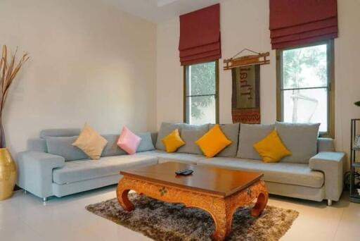 Cozy living room with grey couches and colorful throw pillows