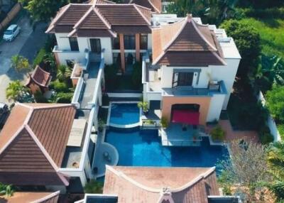 Aerial view of a large residential property with pool