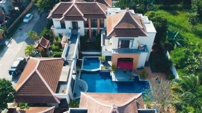 Aerial view of a large residential property with pool