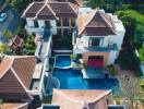 Aerial view of a large residential property with pool