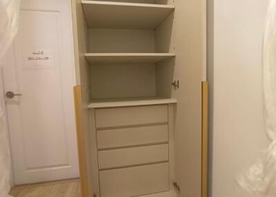 Spacious built-in storage cabinet with open shelves and drawers