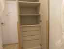 Spacious built-in storage cabinet with open shelves and drawers