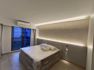 Modern bedroom with a large bed and ambient lighting