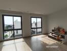 Spacious living room with large windows and wooden floor