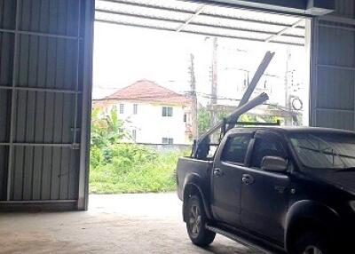 Garage space with an open door and a pickup truck