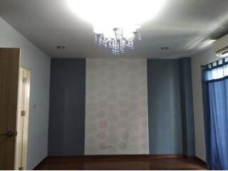 Empty bedroom with chandelier and wall decor