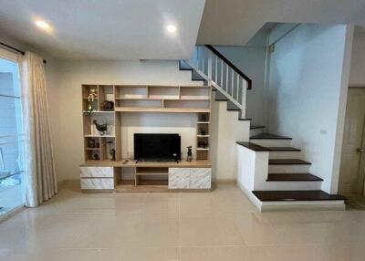 Modern living room with built-in TV cabinet and stairs