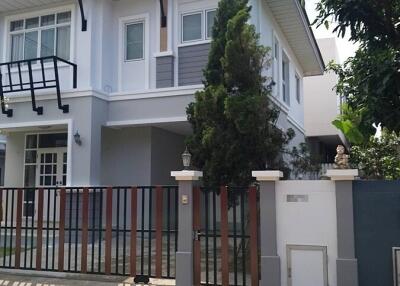 Two-story house with a gated entrance