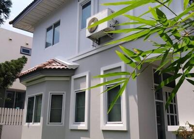 Exterior view of a modern two-story house with a well-maintained garden