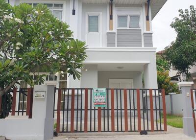 Modern two-story house with a front yard and gate