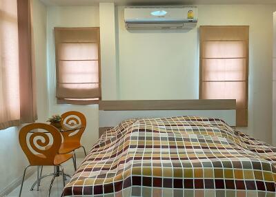 Bedroom with double bed, air conditioner, and small dining area