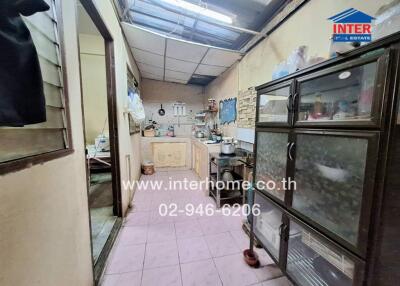 Small kitchen with light pink tiles and appliances