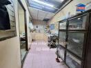 Small kitchen with light pink tiles and appliances