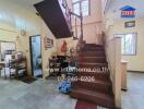 Interior staircase area with adjacent storage and kitchen