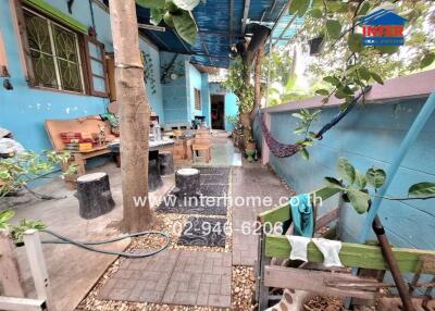 Outdoor seating area with plants and decorative elements