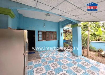 Covered outdoor area with blue walls and decorative flooring