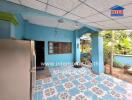 Covered outdoor area with blue walls and decorative flooring