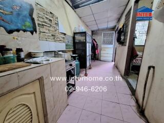 Simple kitchen setup with basic essentials and a passage towards the back door