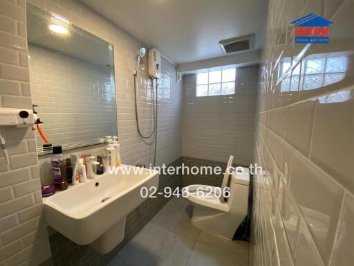 Modern bathroom with sink, mirror, toilet, and shower