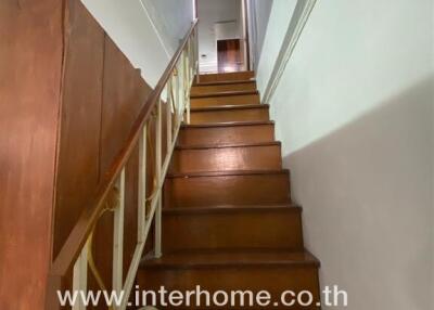 Staircase with wooden steps and railing