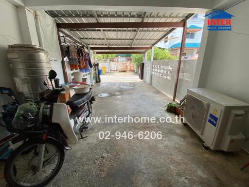 Garage with various items and covered roof