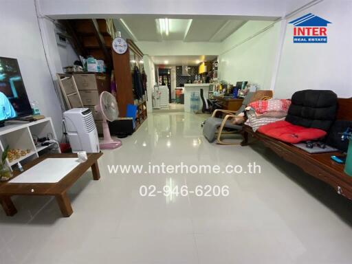 Spacious and bright living room with tiled flooring, furniture, and television