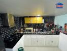 Modern kitchen with black tiled backsplash and yellow cabinets