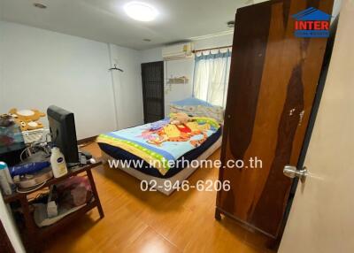 Cozy bedroom with wooden flooring