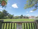 Vacant land for sale with greenery and houses in the background