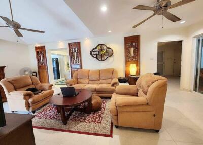 Cozy living room with beige sofas and decorative wooden elements