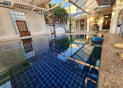 Indoor swimming pool area with surrounding amenities