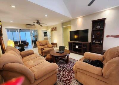 Spacious living room with comfortable seating and entertainment setup