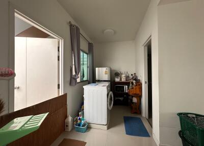 Laundry room with washing machine and storage area