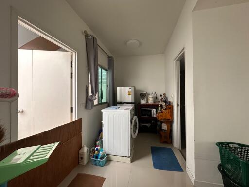 Laundry room with washing machine and storage area