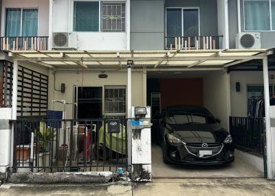 Front view of a two-story house with carport