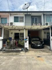 Front view of a two-story house with carport