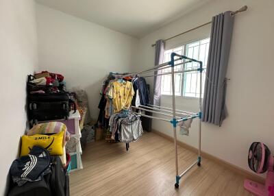 A bedroom used for storage and laundry