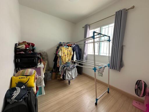 A bedroom used for storage and laundry