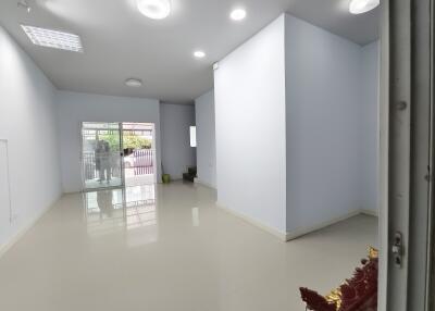 Well-lit living room with large windows and modern lighting fixtures