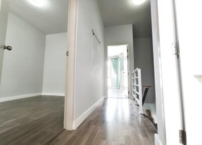 Hallway leading to different rooms with visible stairs