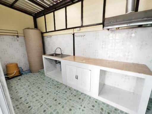 Simple kitchen with tiled flooring and countertop