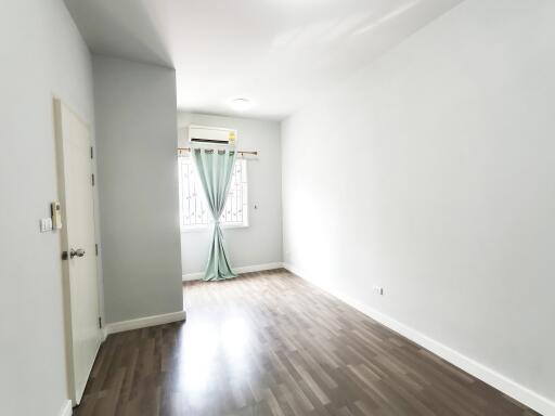 Bright empty bedroom with window and air conditioning