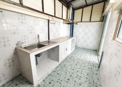 Simple kitchen with tiled flooring and backsplash