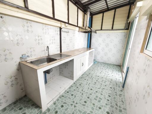 Simple kitchen with tiled flooring and backsplash