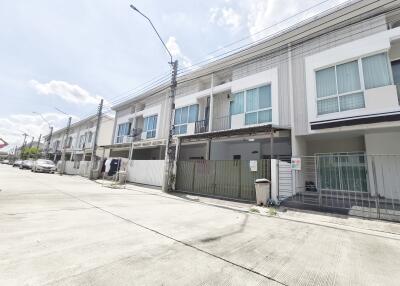 View of modern townhouses with balconies and garage spaces