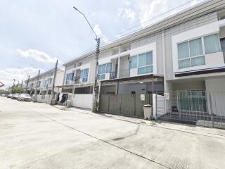 View of modern townhouses with balconies and garage spaces