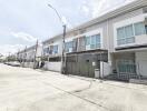 View of modern townhouses with balconies and garage spaces