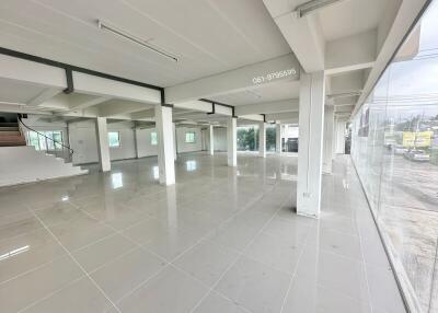 Spacious open-floor plan in a commercial building with ample windows