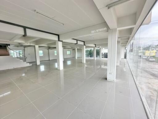 Spacious open-floor plan in a commercial building with ample windows