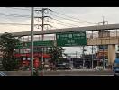 Street view with overpass and traffic signs